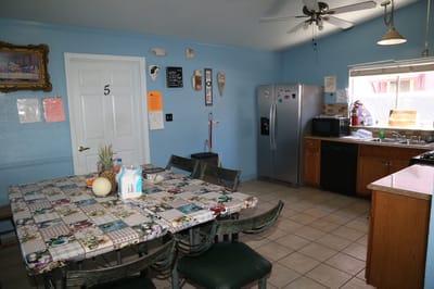 Bright kitchen area with dining table and appliances.