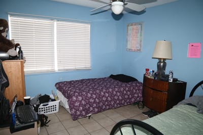 Sleep area with bedding and furniture
