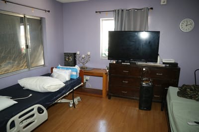 Private resident room with beds and furniture.