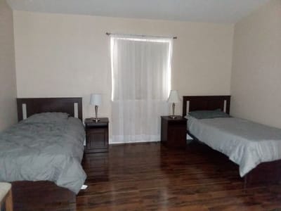 Private resident room with two beds and natural light