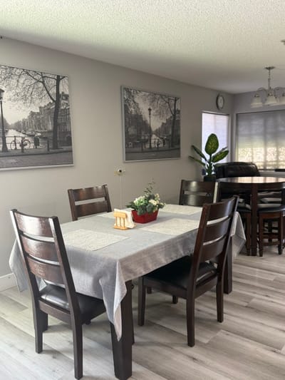 Bright dining area with wooden tables and decorative plant
