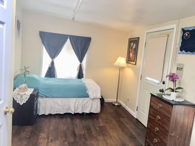 Cozy private resident room with bed and decor