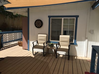 Outdoor seating area with chairs and a dartboard