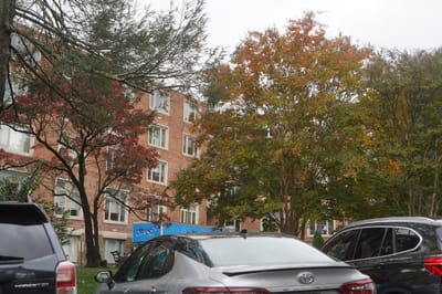 Exterior view of a senior living facility with fall foliage