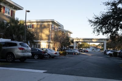 Exterior view of the Beach House facility with parking