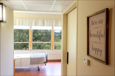 Bright interior view of a resident room with a positive quote