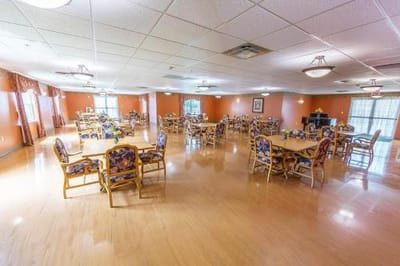 Bright dining room with tables and chairs set up