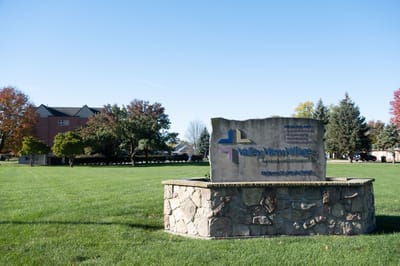 Facility sign for Valley View Village in outdoor setting