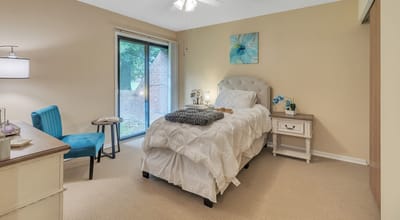 Cozy resident room with a bed and window view