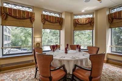 Dining room setup with view of outside trees
