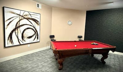 Interior room with a pool table and artwork