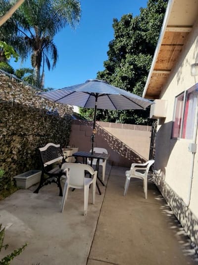 Outdoor seating area with an umbrella and chairs