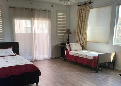 Private resident room with two beds and natural light