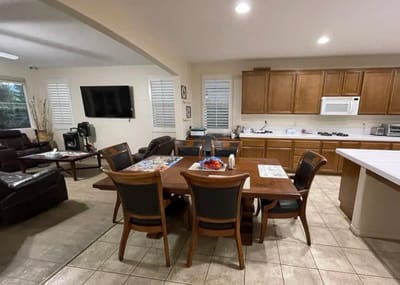 Bright common area with dining table and kitchen