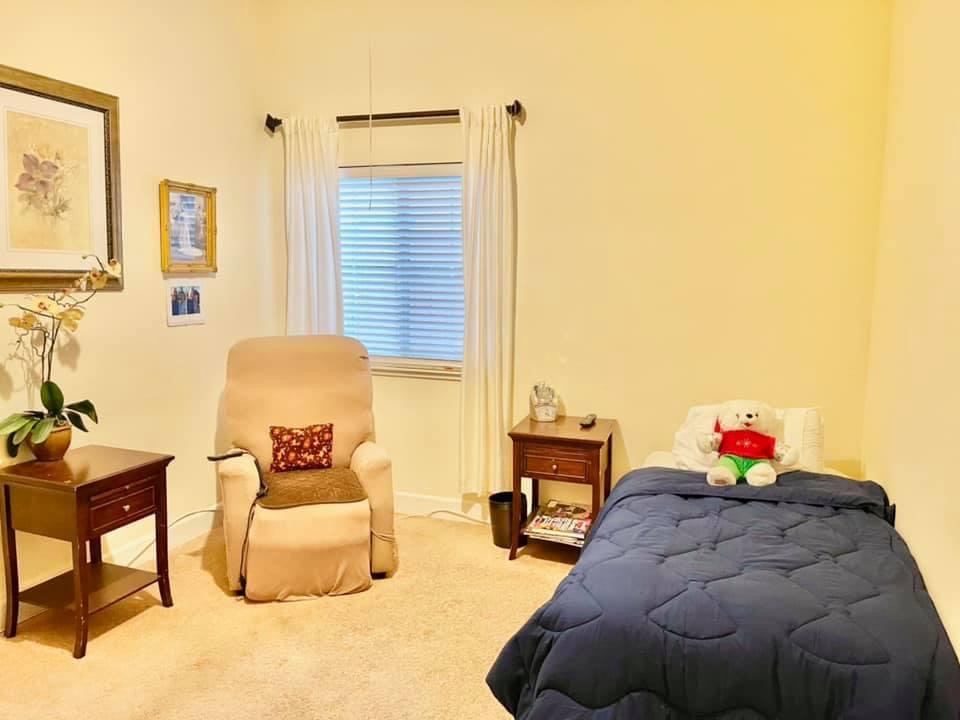 Cozy resident room with a chair and teddy bear