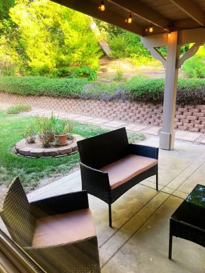 Outdoor seating area with chairs and garden view