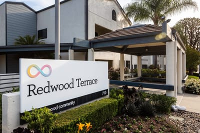 Exterior view of Redwood Terrace entrance with signage
