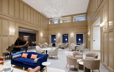 Interior view of a common area with seating and piano