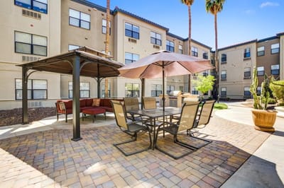 Outdoor seating area with tables and umbrellas