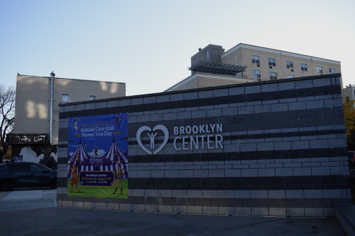 Exterior view of Brooklyn Center with promotional banner.