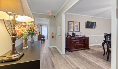 Bright common area with flowers and decor.