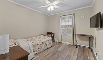 Cozy resident room with a bed and desk.