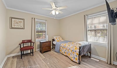 Private resident room with bed and chair