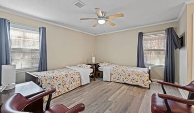 Shared resident room with two beds and decor.