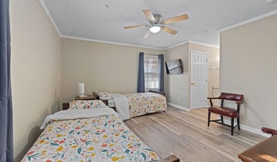 Shared room with two beds and a chair
