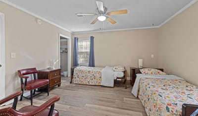 Cozy resident room with two beds and floral bedding