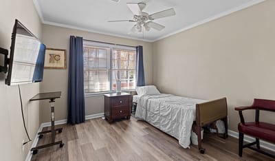 Single resident room with bed and furniture