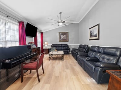 Cozy common area with seating and piano.