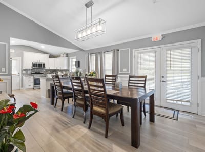 Bright common area with dining table and kitchen
