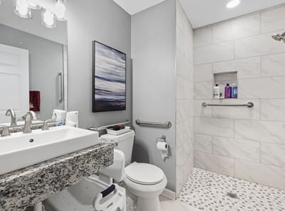 Well-lit bathroom with modern features and décor.