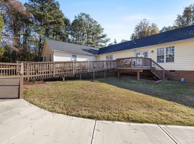 Accessible outdoor pathway with grass and trees.