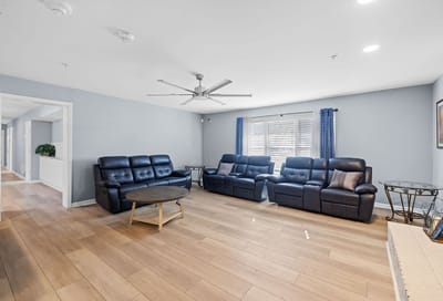 Bright common area with seating and large windows.