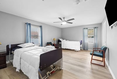 A shared resident room with two beds and natural light.