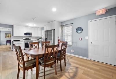 Dining area with a large round table and chairs.