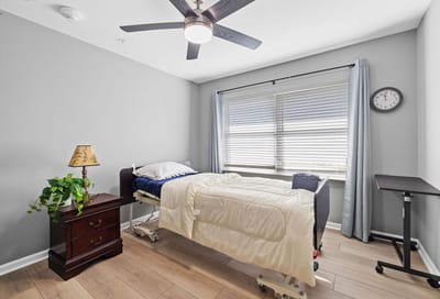 Patient room with a bed and side table