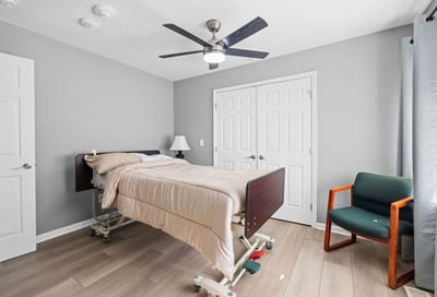 Private resident room with adjustable bed and chair.