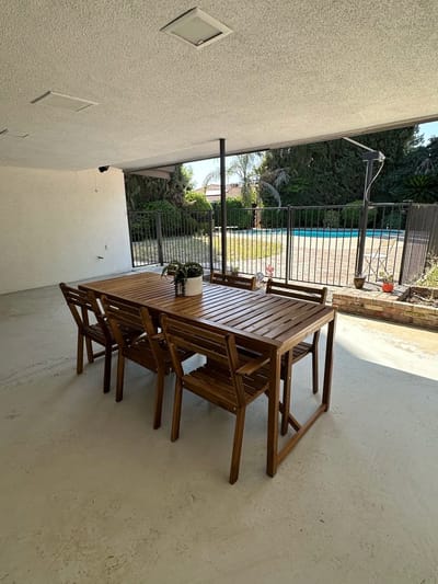 Outdoor dining area with a table and pool view