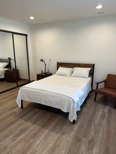 Cozy private room with a bed and chair