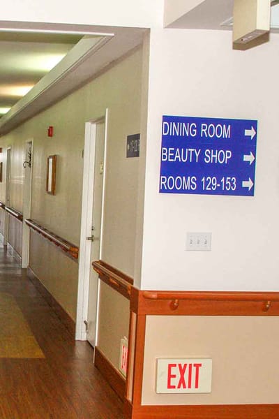 Interior hallway with signs for dining and beauty shop