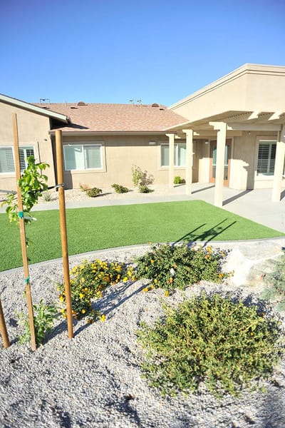 Exterior view of a senior living facility with landscaping