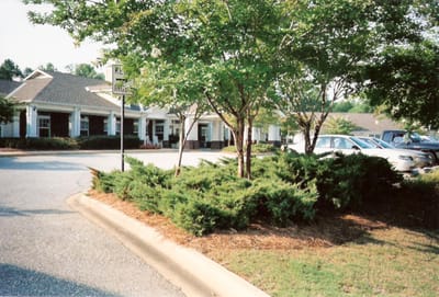 Outdoor view of Camellia Place with trees and parking