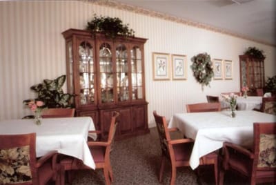 Interior dining area with tables and decorative cabinet