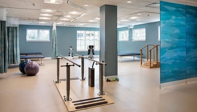 Physical therapy area with exercise equipment and rehabilitation tools