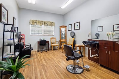 Bright hair salon area with seating and mirrors