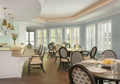 Bright dining room with tables set for meals