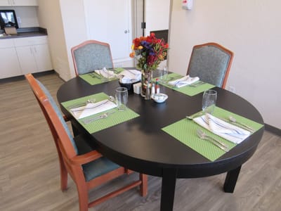 Dining table set with tableware in a common area